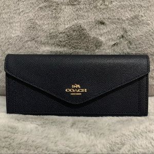 Never been used Coach wallet in navy blue color! Plenty of compartments!